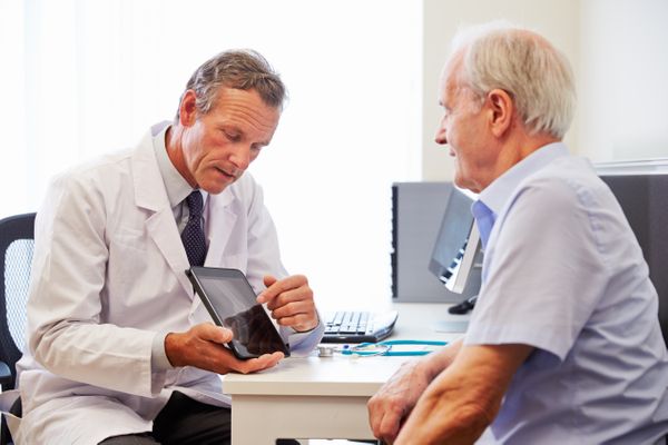 A Pharmacist speaks to their patient about medicare open enrollment Medicare Open Enrollment